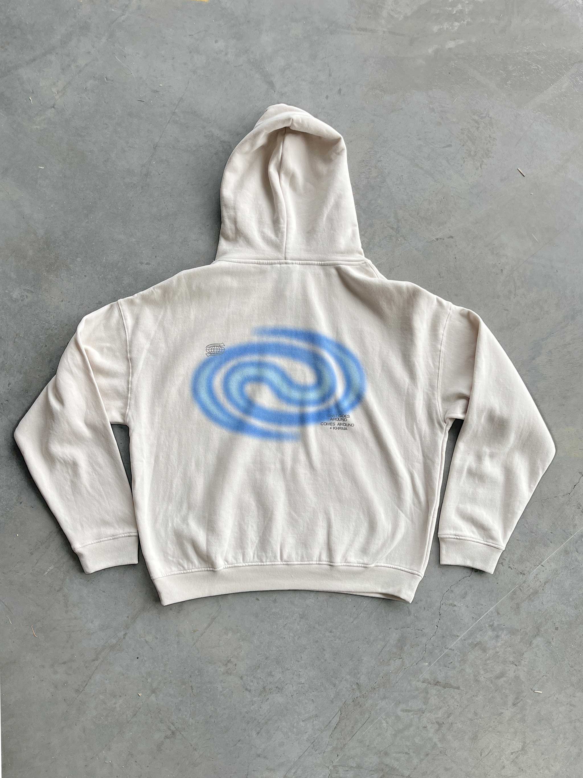 White hoodie with a blue spiral design on the back