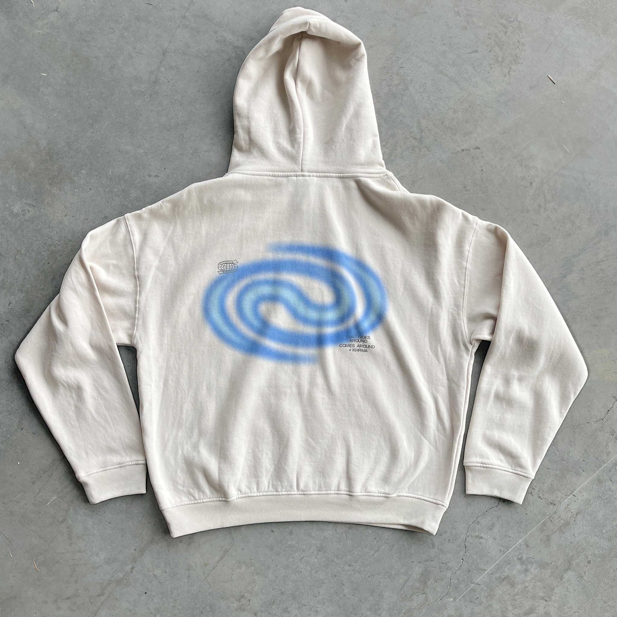 White hoodie with a blue spiral design on the back
